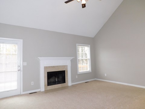 a living room with a fireplace and a door