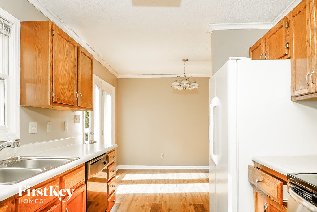 A kitchen with wooden cabinets and a white refrigerator.