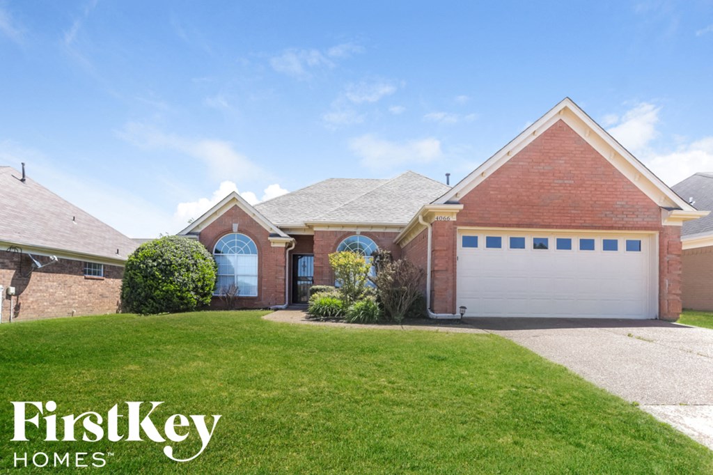 A house with a garage and a driveway is for sale.