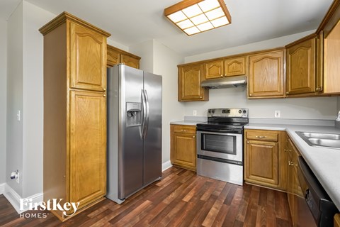 A kitchen with wooden cabinets and stainless steel appliances.