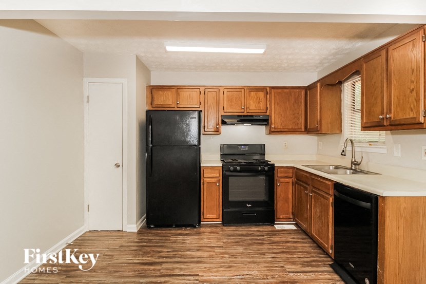 a kitchen with black appliances and wooden cabinets