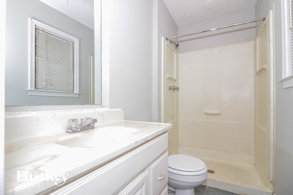 a bathroom with a sink toilet and a shower