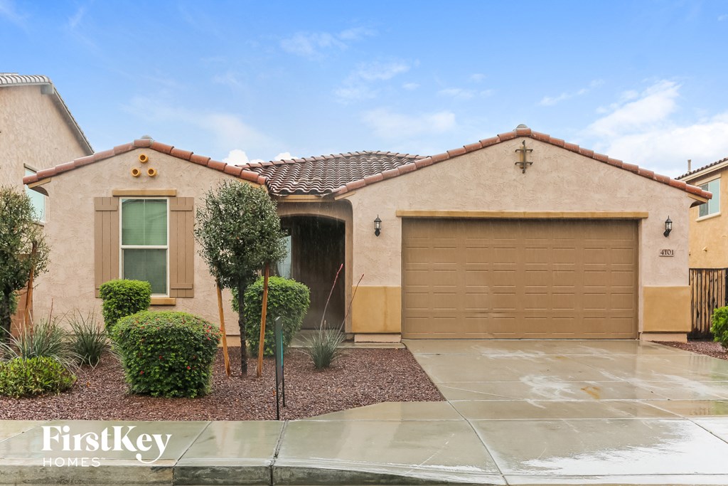 a house with a garage door and a driveway in front of it