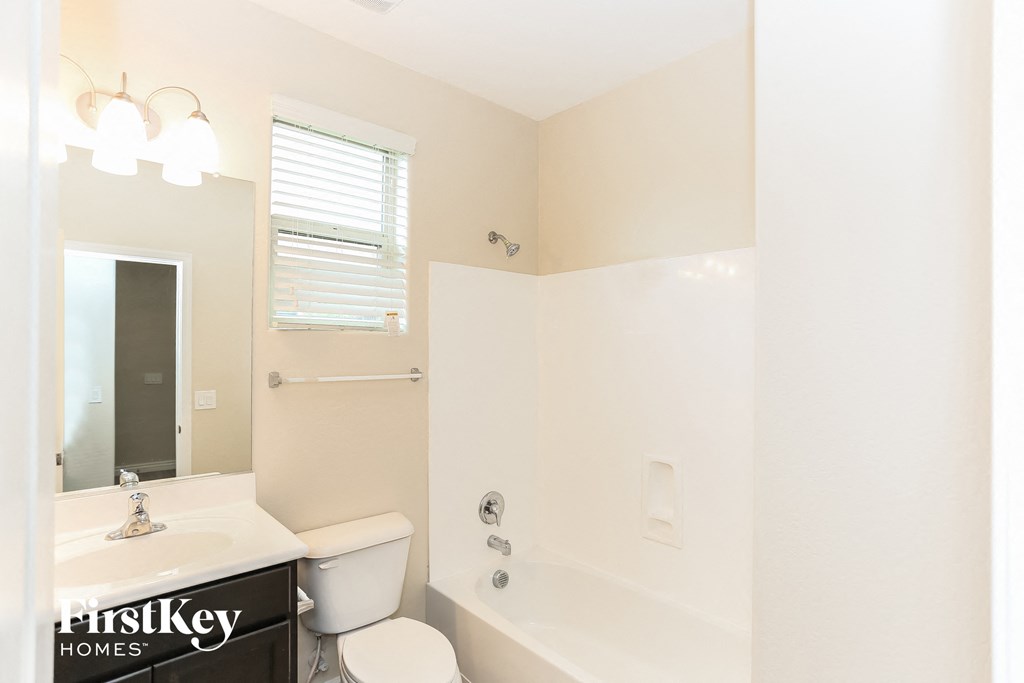 a bathroom with a tub and a toilet and a sink