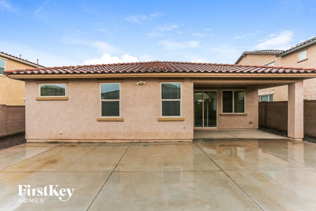 a home with a large patio in front of it