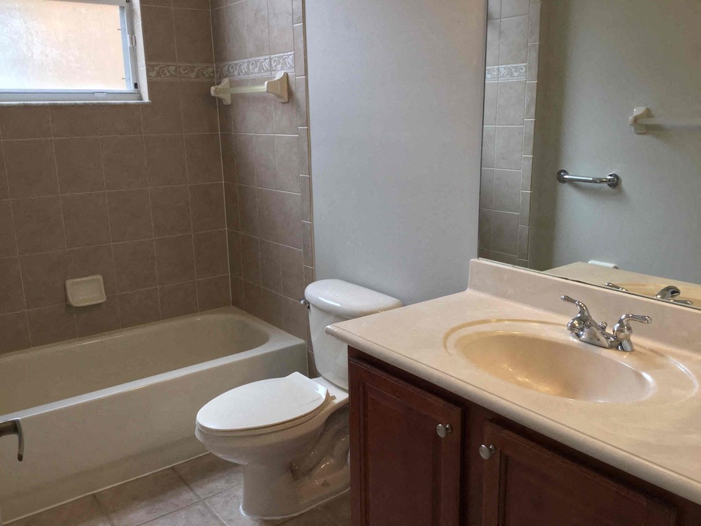 a bathroom with a sink toilet and a bath tub