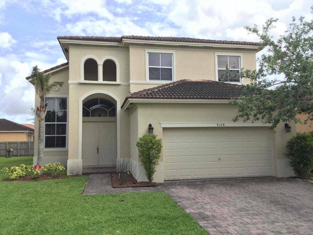 a house with a garage door and a lawn