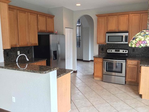 a kitchen with granite counter tops and stainless steel appliances