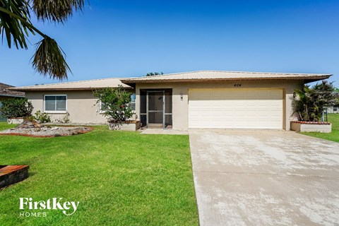 a house with a white garage door and a lawn