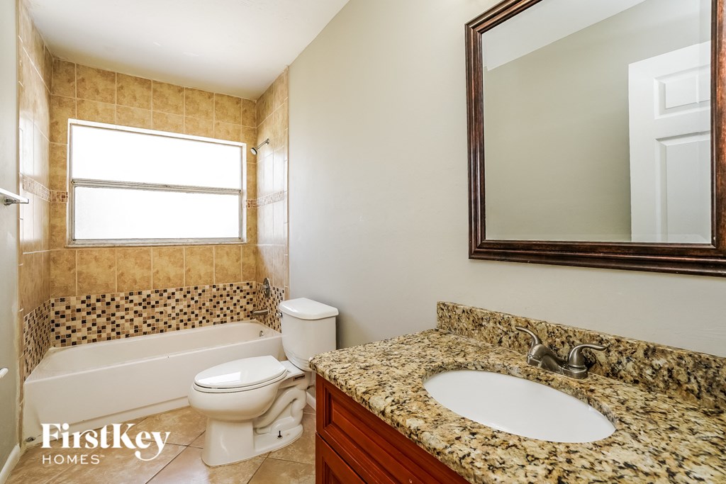 a bathroom with a sink and a toilet and a bath tub