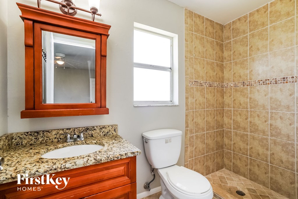 a bathroom with a sink toilet and a mirror
