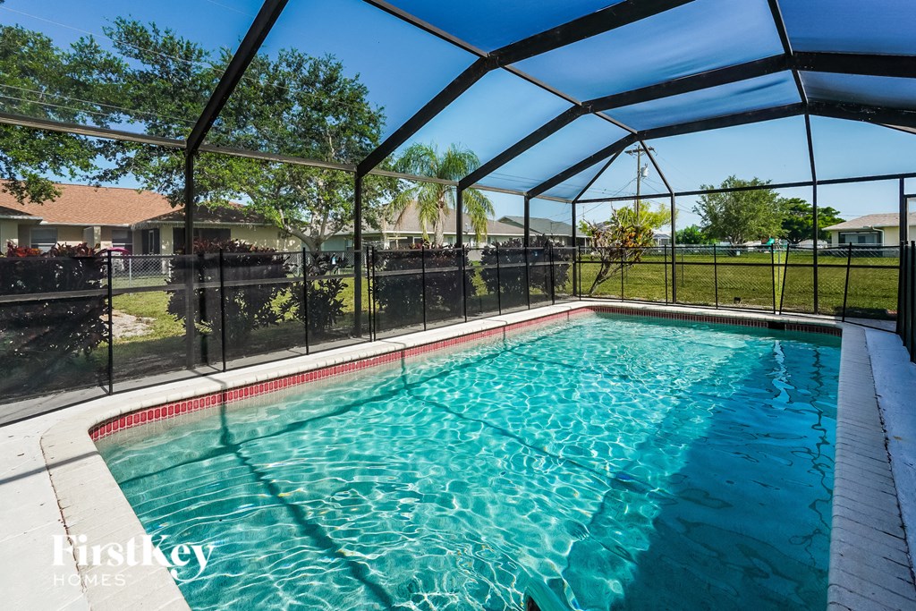 a pool with a fence around it and a swimming pool