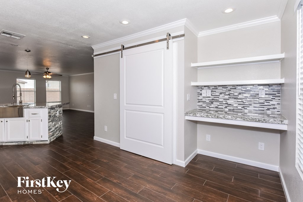a kitchen with a large white door and a counter top with a sink