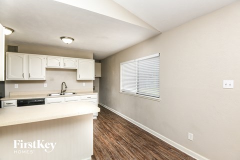A kitchen with white cabinets and a countertop.