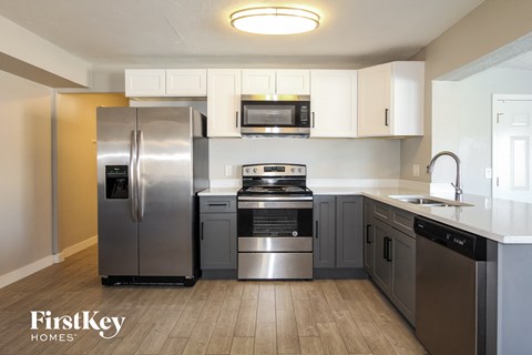 a kitchen with stainless steel appliances and white cabinets