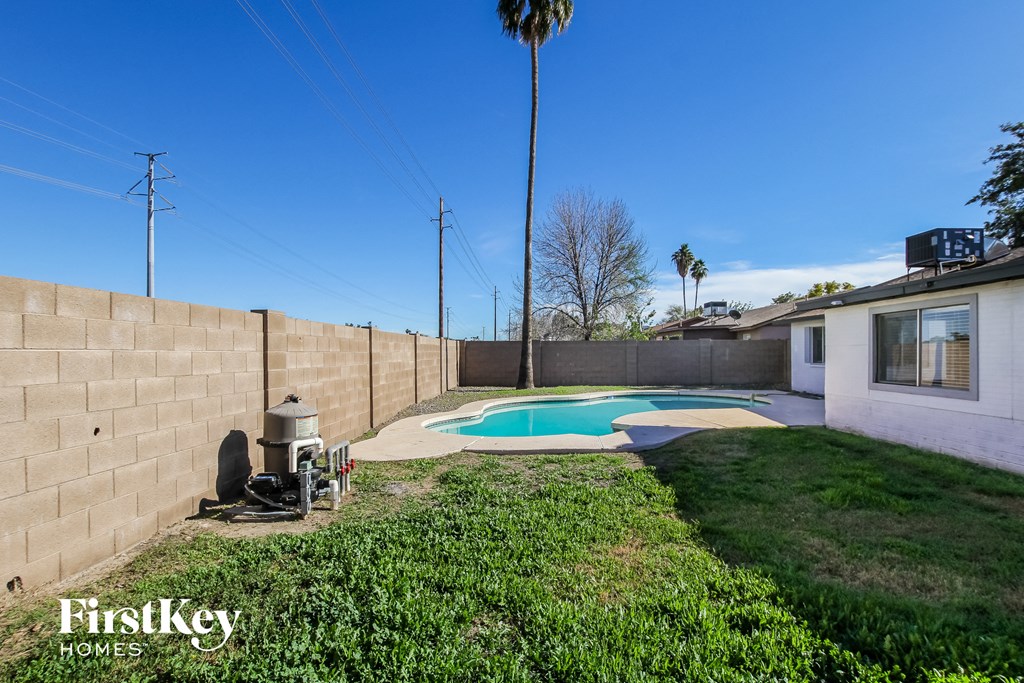 a backyard with a pool and a house