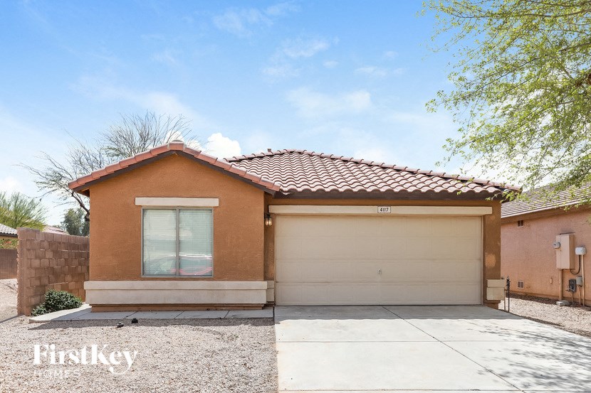 A house with a brown roof and a garage door.