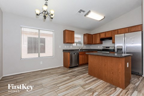 A kitchen with wooden cabinets and a refrigerator.