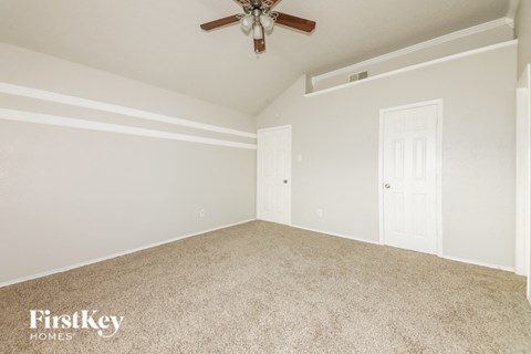 the living room of a home with a ceiling fan
