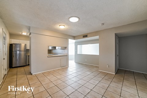 a kitchen with a stainless steel refrigerator and a sink