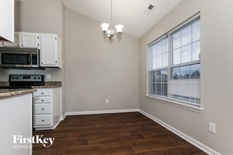 A kitchen with a microwave and oven built into the cabinetry.