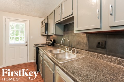 A kitchen with a sink and a window.
