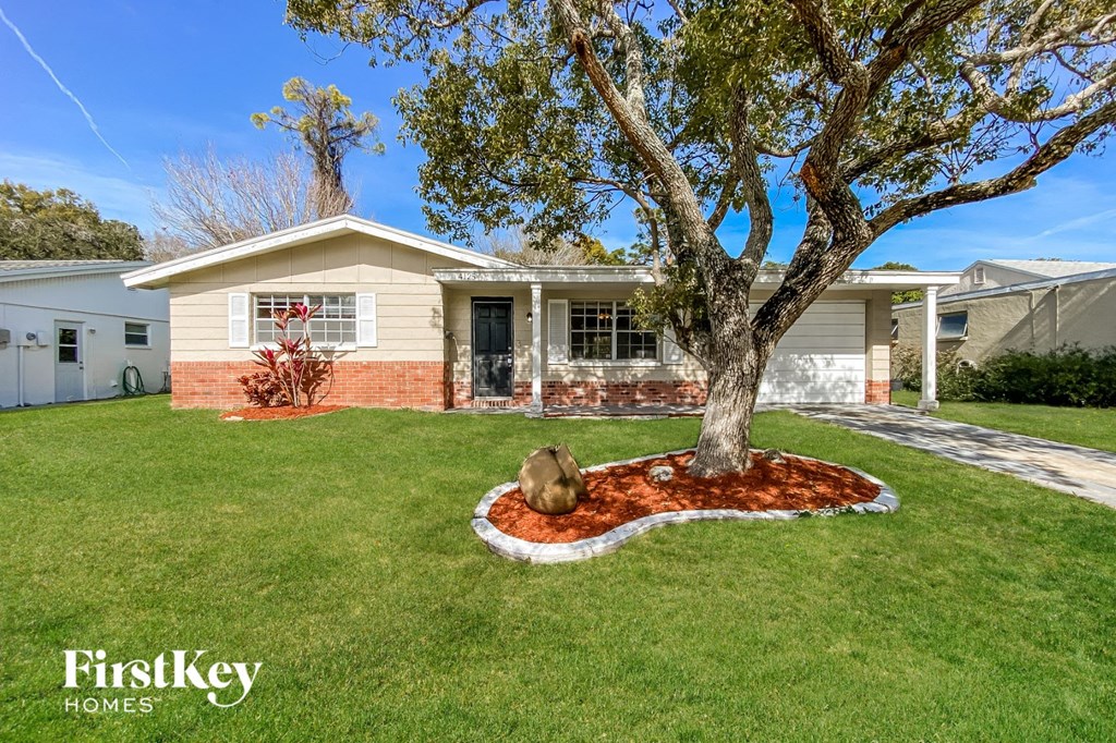 A house with a tree in front of it.
