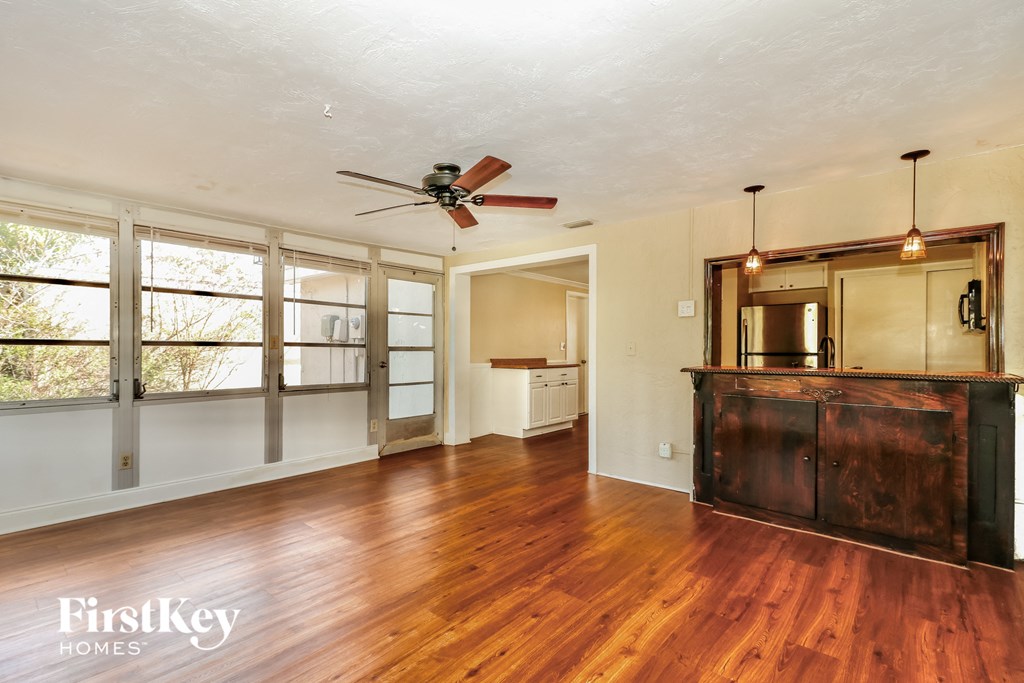 A room with wooden floors and a ceiling fan.