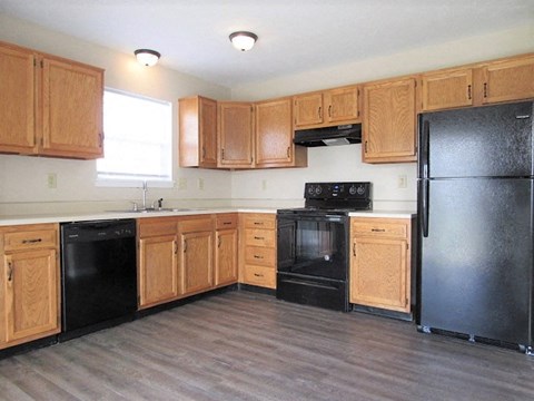 a kitchen with black appliances and wooden cabinets