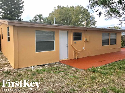a small brown house with a door and a window
