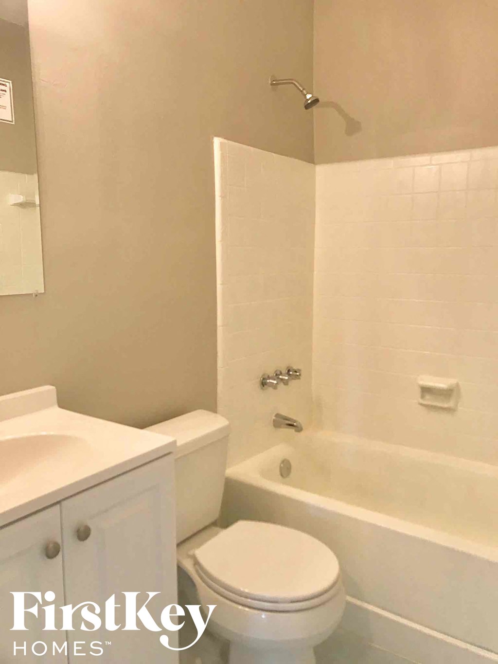 a bathroom with a toilet and a tub and a sink