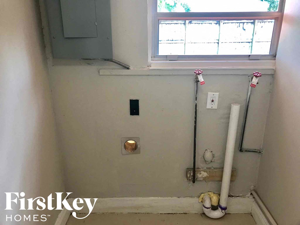 a small bathroom with a window and a toilet in it