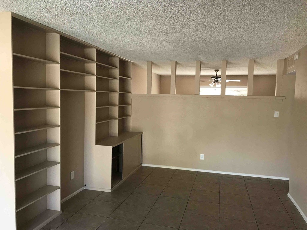A room with a brown floor and a white ceiling with a light fixture.