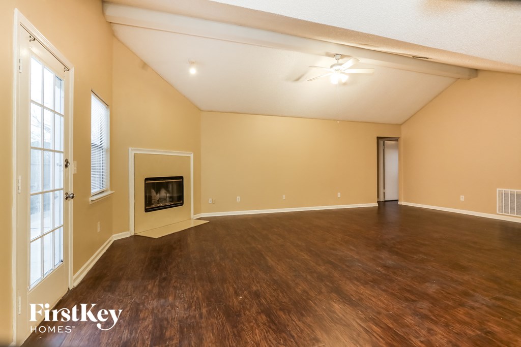 the living room of an empty house with a fireplace