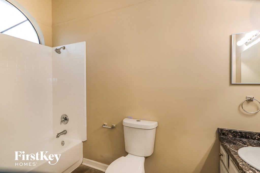 a bathroom with a toilet and a shower and a sink