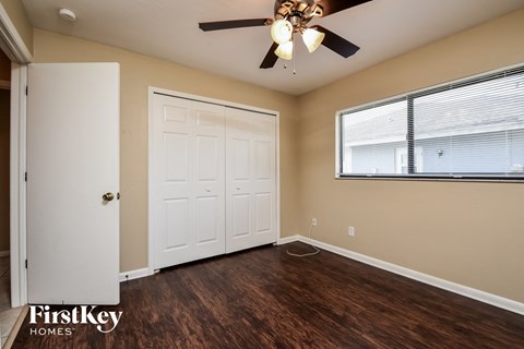 the living room of an updated home with a ceiling fan