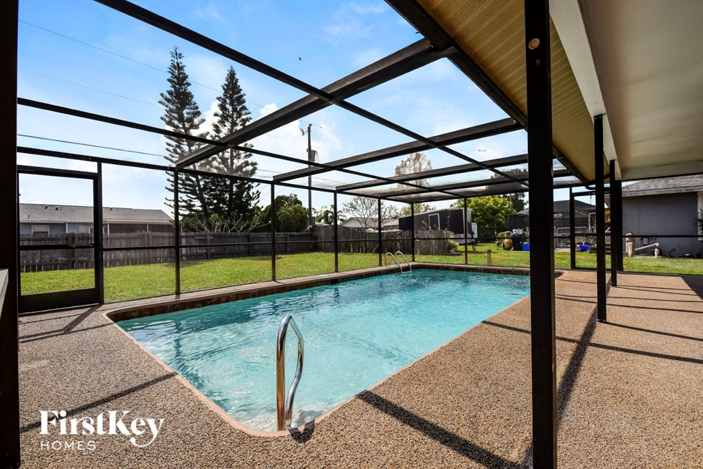 a pool with a fence around it in a backyard