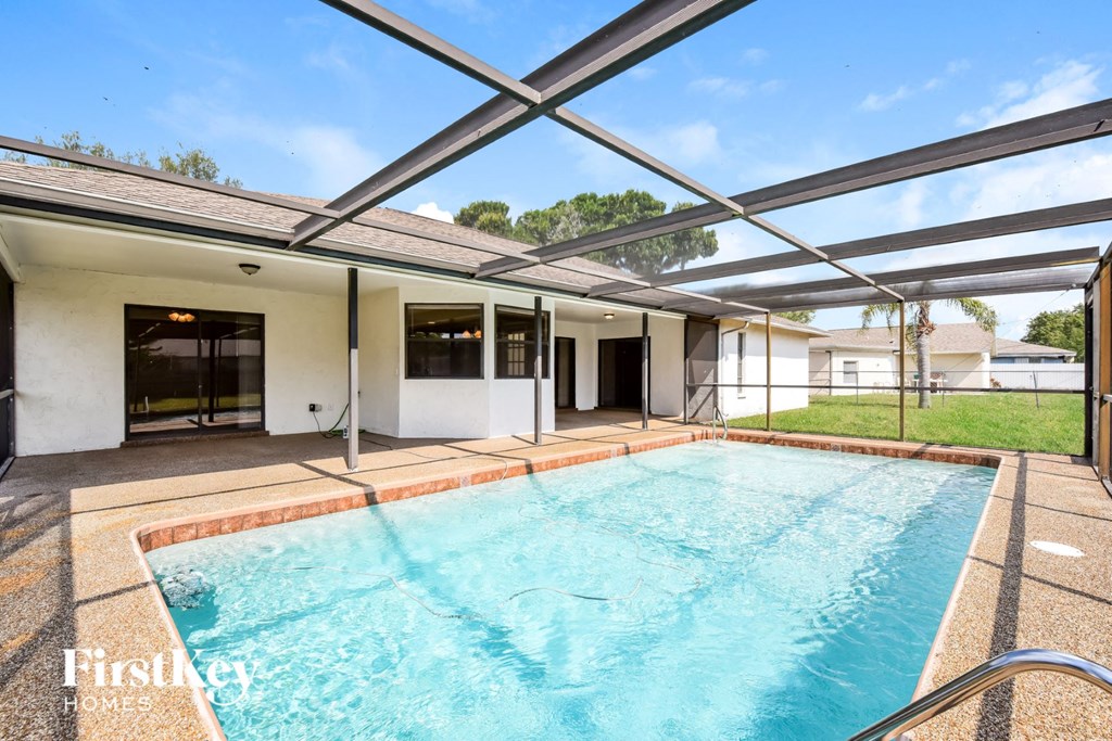 a swimming pool in a house with a large pool