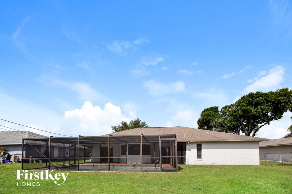 a house with a screened in porch and a roof top patio