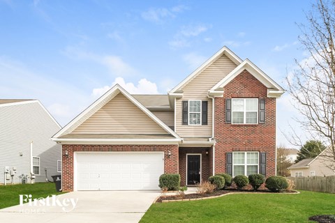 a brick house with a white garage door