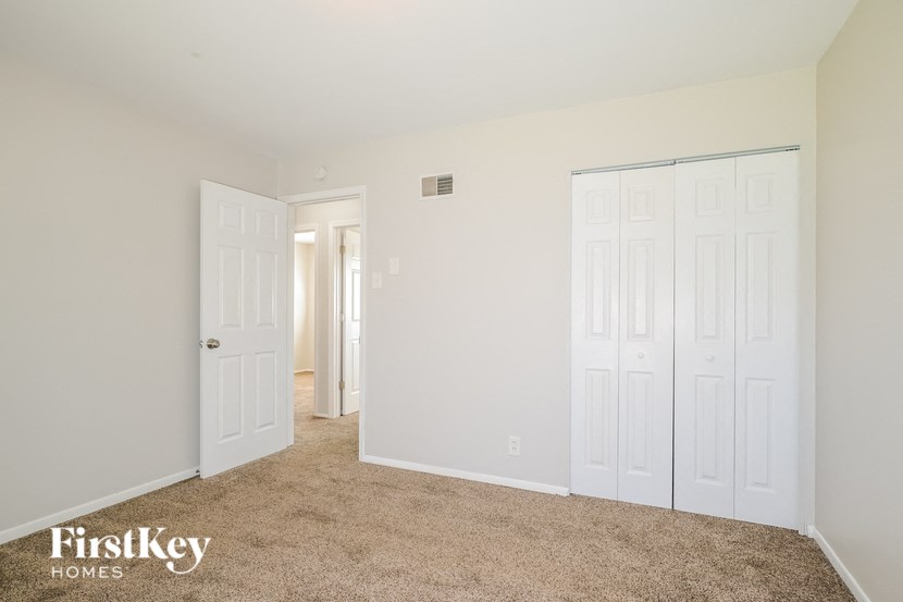 a bedroom with two closets and a door to a hallway