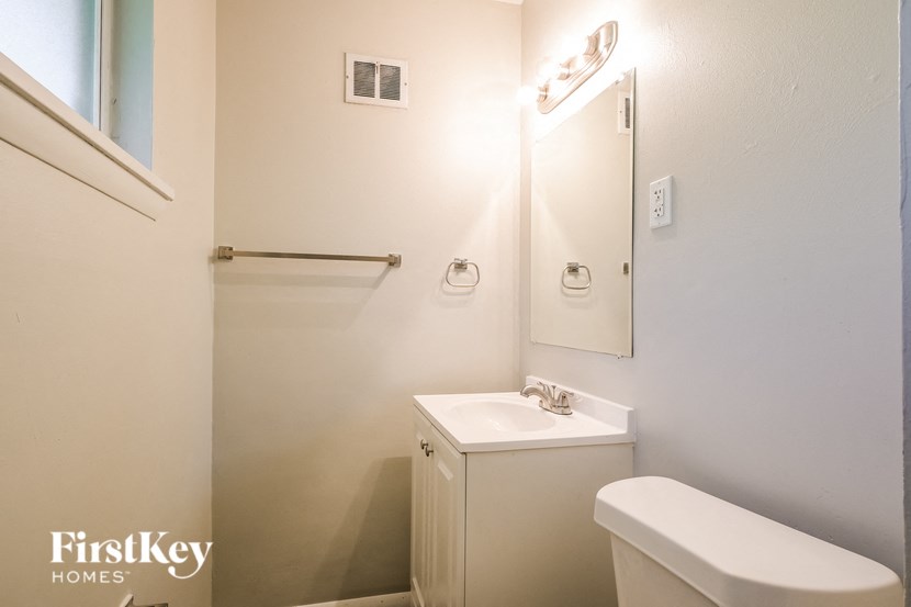 a bathroom with a sink and a toilet and a mirror