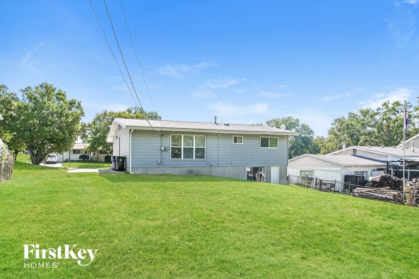 a blue house on top of a green yard