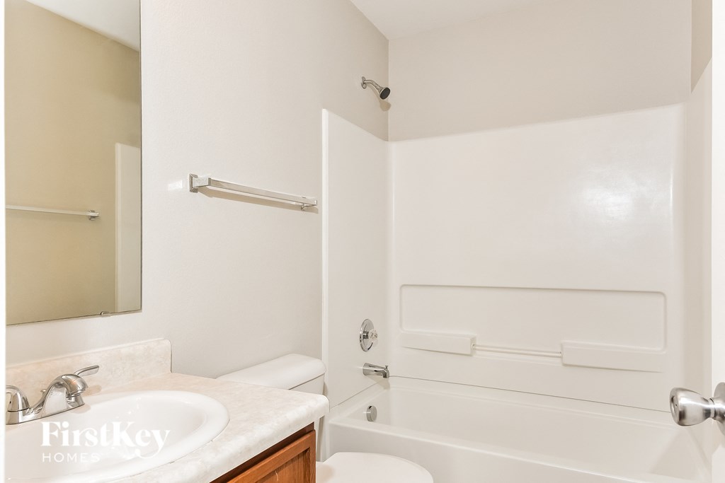 a bathroom with a sink and a toilet and a bath tub