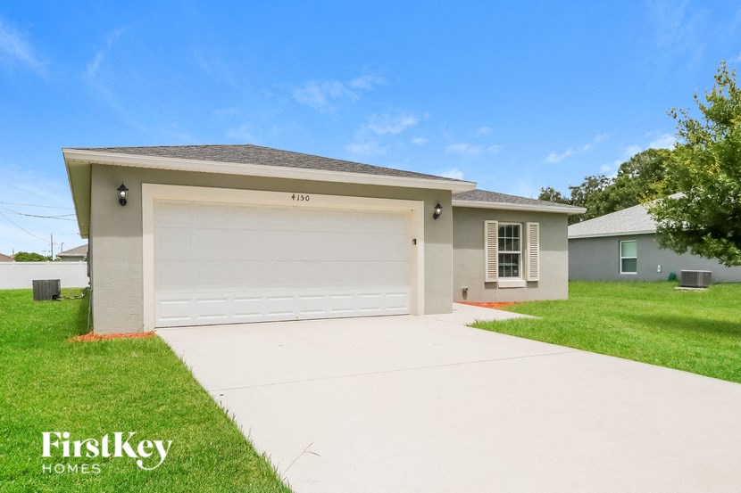 a beige house with a white garage door
