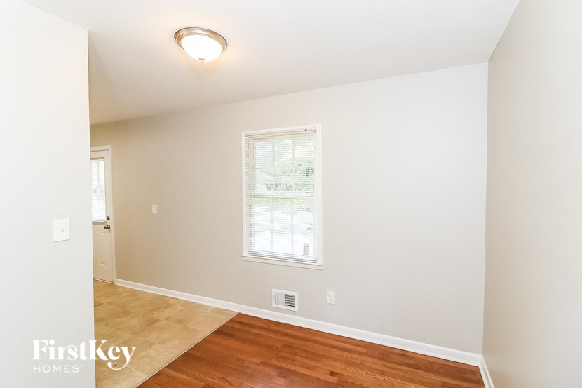 a living room with a hard wood floor and a window