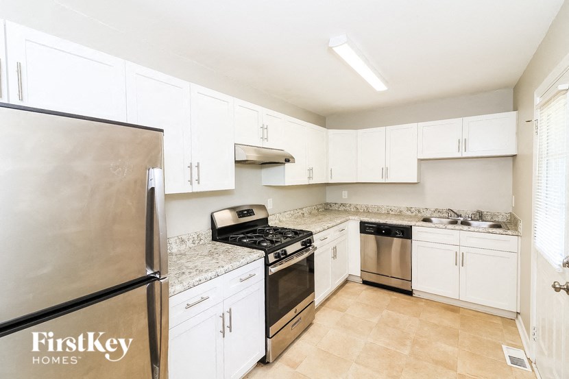 a kitchen with stainless steel appliances and white cabinets