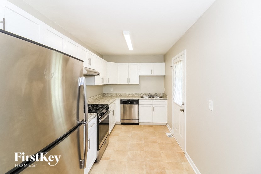 a kitchen with stainless steel appliances and white cabinets