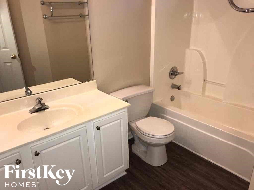 a bathroom with a sink toilet and bath tub