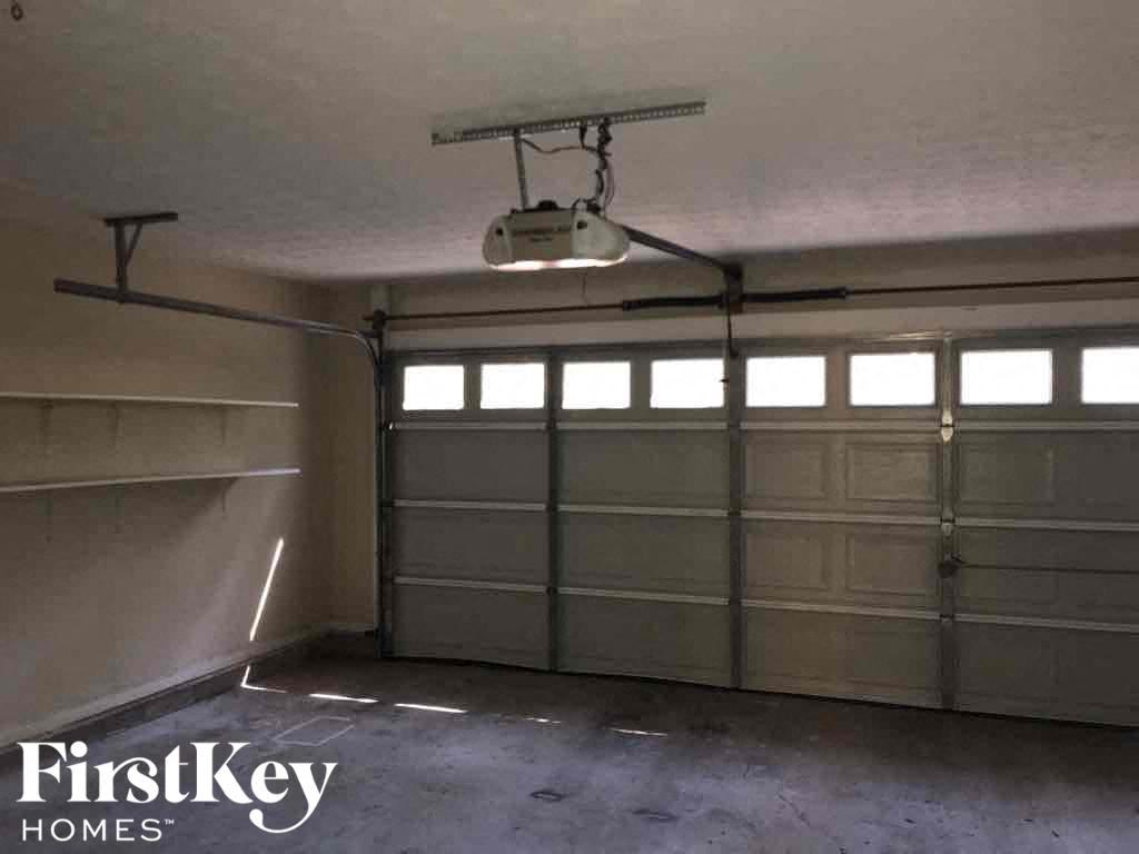 the inside of a garage with white garage doors